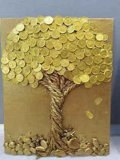 a tree made out of gold coins sitting on top of a table