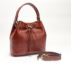 Featuring a grommeted drawstring for easy opening, this leather beauty makes is the perfect take-anywhere bag. There's plenty of room for your necessities, and you can carry it by the top handles or the adjustable/detachable crossbody strap. From Patricia Nash. Textured Leather Satchel Bucket Bag For Shopping, Pebbled Leather Textured Satchel Bucket Bag, Artisan Brown Bucket Bag With Leather Handles, Bucket Bag With Textured Leather For On-the-go, Leather Satchel Bucket Bag With Silver-tone Hardware, Leather Bucket, Leather Bucket Bag, Fashion Handbags, Tote Handbags