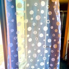 a curtain with white and blue polka dots on it