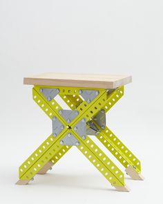 a wooden table with yellow and grey metal legs on it's sides, against a white background