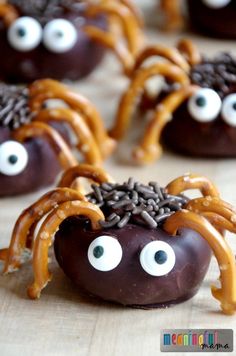 chocolate covered pretzels decorated with googly eyes and spider webs for halloween