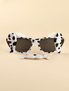 a pair of sunglasses with black and white spots on them