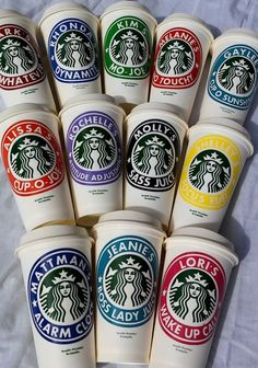 six cups of coffee with the names of different starbuckss on them are lined up in a row