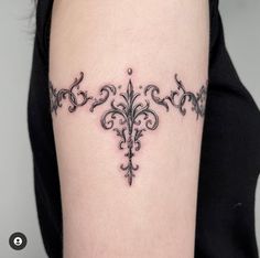 a woman's arm with a tattoo on it that has an ornate design in the middle