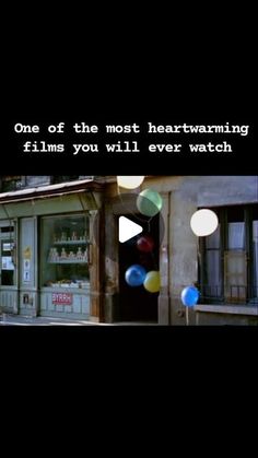 an old building with balloons in front of it that says, one of the most heartwarming films you will ever watch