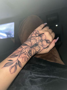 a woman's arm with flowers on it