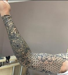 a man with tattoos on his arm and arms