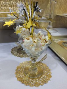 a glass bowl filled with popcorn on top of a table