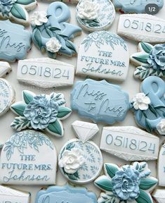 decorated cookies with blue and white frosting on top of each cookie is the date