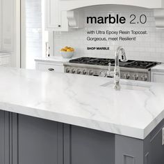 a kitchen with marble counter tops and white cabinets, along with an advertisement for marble 2 0