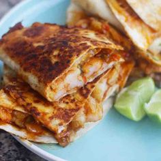 a plate with some quesadillas and avocado on it