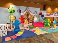 an indoor play area with lots of toys and decorations on the floor, including candy land