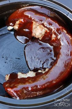 the meat is being cooked in the slow cooker and then covered with bbq sauce