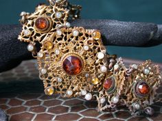 "WE SELL THIS NICE ANTIQUE AUSTRO HUNGARIAN BRACELET, MADE IN METAL WITH GOLD GILT FINISHED DECORATED WITH STONES and faux seed PEARLS , IN GOOD CONDITION ,HAS SOME SIGNS OF WEAR COMMENSURATE WITH AGE AND USE , MAYBE NEEDS SOME CLEANNING, HAS SOME STAINS, MISSING little seed pearl, PLEASE SEE PICTURES AND TAKE AS A PART OF ITEM DESCRIPTION, i list for sale ASIS as pictured the measures are 7 3/4\" X 1 1/2\"WEIGHT 33.3gr As is a vintage antique item , it's unique , for that if you like to wear it Victorian Jeweled Bracelets For Formal Occasions, Victorian Bracelets With 17 Jewels For Evening, Vintage Yellow Gold Bracelet With Jewels, Vintage Yellow Gold Bracelets With Jewels, Antique Jeweled Gold Bracelets, Vintage Jewelry With Historical Design For Evening, Antique Bronze Bracelet For Wedding, Victorian Style Gold Bracelets For Wedding, Victorian Gold Bracelets For Wedding