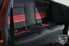 the back seats of a car with red and black trimmings are shown in this image