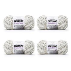 four balls of bernat crocheted wool in white and grey colors on a white background