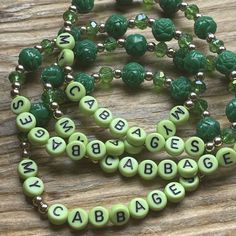 a green beaded necklace with letters that spell out the word babble on it