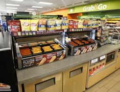 the food section of a grocery store with donuts and other items