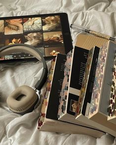 an open book and headphones on a bed