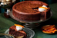 a chocolate cake with whipped cream on top and sliced peaches in the bottom plate