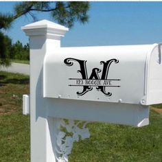 a white mailbox with the letter w on it