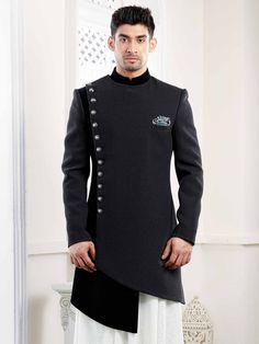 Black colour Designer Indowestern in different cut & style detailed with the buttons that compliment the dress This can be Worn with or without the kurta inside with the straight fitted trousers.A must have in the wedding collection of a men.Customize it to your measurement for the best fit. COST INCLUDES INDOWESTERN,KURTA,TROUSER Latest Indowestern Outfits For Men, Indowestern Outfits For Men, Unique Mens Wedding Suits, Marriage Clothes, Indo Western For Men, Groom Sherwani, Wedding Kurta For Men, Boys Kurta Design, Wedding Dresses Men Indian