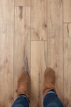 a person standing on top of a wooden floor