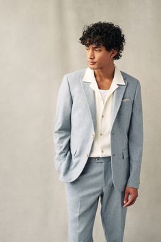 a man in a blue suit and white shirt