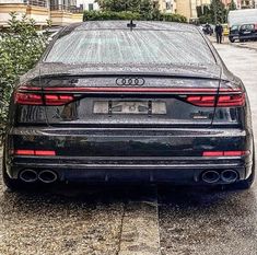 the back end of an audi car parked on a street