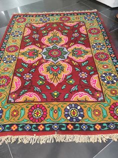 a colorful rug with fringes on the floor