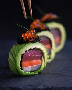 sushi rolls with salmon, avocado and black sesame seeds