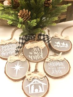 christmas ornament ornaments are arranged on a table with pine cones and plaid ribbon