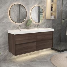 a bathroom with two round mirrors above the sinks and a walk in shower behind it