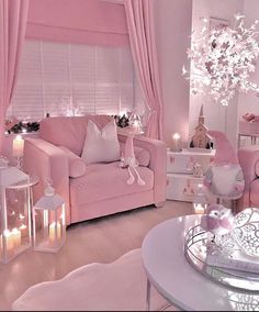 a living room filled with pink furniture and lots of lights on the windows sill