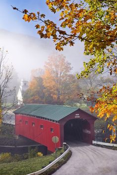 a red covered bridge with the words good morning on it and trees in the background