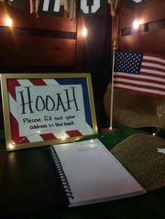 a sign that says hooah placed in front of a notebook and american flags