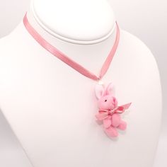 Details: Bunnies are 1" (2.5cm) wide & 2" (5cm) long Pink satin ribbon choker is 1/4" (6mm) wide & adjustable up to 16" (40cm) or 20" (50cm) Wear as a choker or adjust longer for a necklace length White & Blue or Pink Plush miniature bunnies with moveable arms & Legs Closes with a silver finish lobster clasp Finished with a signature Fatally Feminine Designs Heart Charm Handmade & Limited Matching earrings or Necklace Available (search "plush bunny") *Care note: bunnies are made of fabric, pleas Pink Heart-shaped Choker Gift, Adjustable Cute Pink Choker, Adjustable Pink Kawaii Jewelry, Satin Choker, Pink Ribbon Choker, Handmade Pink Harajuku Style Necklace, Princess Courtney, Ribbon Choker, Bunny Care