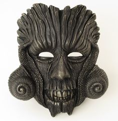 This unique and stunning mask, individually sculpted and handpainted, looks great on a wall and can be worn for parties.  The creation of this mask was inspired by the character of Green Man and His mysterious dark night aspect. This one-of-a-kind original art piece, which you can wear on various occasions or simply display it as a striking and eye-catching home ornament, is made of mixed resin and talc as well as fiberglass cloth. It was created through a complex process, which started with modelling the mask in Plasticine modelling clay and producing a handmade silicone mold. Later it was painted by hand with high quality artistic acrylic paints - black and metallic - and fine tip paint brushes. Height: 22 cm/ 8.7 in Width: 20 cm/ 7.9 in Depth: 11 cm/ 4.3 in Weight: 403 g/ 14.2 oz Artistic Halloween Masks For Theater, Artistic Masks For Theater And Halloween, Artistic Halloween Theater Masks, Artistic Masks And Prosthetics For Theater Halloween, Artistic Halloween Masks For Fantasy Events, Fantasy Eye Mask For Themed Events, Artistic Masks And Prosthetics For Themed Events, Artistic Black Masks And Prosthetics For Halloween, Artistic Black Halloween Masks And Prosthetics