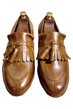 Brown leather loafers with block heels.
Fabric: Leather
Color: Brown
Cutwork and tassel detail - Aza Fashions Brown Oxfords With Tassels And Round Toe, Brown Leather Shoes With Tassels And Round Toe, Tassel Loafers With Round Toe For Galas, Leather Oxfords With Tassels And Round Toe, Brown Tassel Loafers With Round Toe, Leather Slip-on Moccasins With Tassels, Leather Tassel Slip-on Moccasins, Leather Dress Shoes With Tassels And Round Toe, Brown Tasseled Leather Shoes For Galas