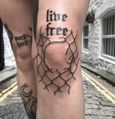 two legs with barbed wire on them and the words live free written in black ink