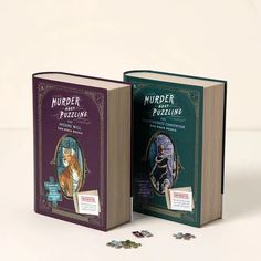 two books with puzzles on them sitting next to each other in front of a white background