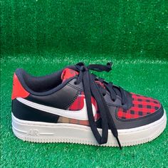 Nike Unveiled The Air Force 1 Low Gs ‘Flannel’ In November 2018. With A Combination Of Red, Black And White, The 1982 Hoops Classic Features A Simple Checkered Pattern On The Toe Box, While A More Complex Tartan Appears On The Midfoot. Black And Red Leather Overlays Provide Contrast On This Kids’ Shoe. The Look Is Completed With A Bright White Swoosh, Midsole And Outsole. Nike Sporty Fall Sneakers, Nike Sporty Sneakers For Fall, Nike Fall Sneakers With Round Toe, Sporty Red Sneakers For Fall, Nike Low-top Sneakers For Fall, Nike Air Force 1 Low, Air Force 1 Low, Checkered Pattern, Kids Nike