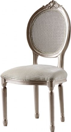 a white chair with an ornate back and seat