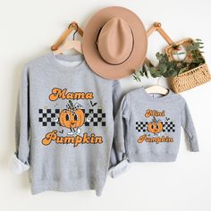 sold separate  Embrace the autumn season with our Pumpkin Halloween Sweatshirt, perfect for creating a cozy Fall Mommy and Me outfit. This Thanksgiving Pumpkin crewneck is ideal for a day at the pumpkin patch or celebrating the season with your little one. Whether it's for a kid's Halloween shirt or a matching mother and daughter look, this sweatshirt is a must-have for all your fall adventures. BODYSUIT  🍼 Durability Matters: Every baby product needs to withstand wear and tear, and this infant Fall Family Matching Crew Neck Tops, Family Matching Cotton Sweatshirt For Fall, Halloween Shirts Kids, Mommy And Me Outfits, Branded Sweatshirts, Fall Sweatshirt, Halloween Sweatshirt, Cozy Fall, Long Sleeve Bodysuit