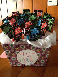 a box filled with lots of candy on top of a wooden table