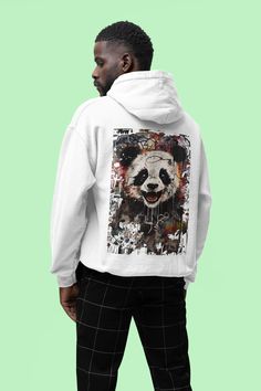 Immerse yourself in the exciting world of street art with our "Urban Panda" graffiti-style shirt. This unique design combines the majestic calm of a panda with the rebellious energy of the street. Product features:
 * Material: 80% cotton, 20% polyester * Grammage: 280 g/m² * Cut: regular fit * Double seam processing * Roughened inside * Hood cord in identical color * Double layer hood * Kangaroo pocket on the front * Knitted cuffs on sleeves and hem White Graffiti Print Hoodie Sweatshirt, White Hoodie Sweatshirt With Graffiti Print, White Cotton Hoodie With Graffiti Print, Urban Cotton Hoodie With Graffiti Print, Urban Crew Neck Hoodie With Graffiti Print, Urban Hoodie With Graphic Print, White Urban Sweatshirt With Graffiti Print, Urban Graffiti Print Sweatshirt For Streetwear, Urban Sweatshirt With Graffiti Print For Streetwear