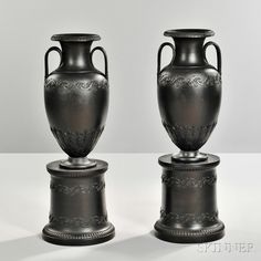 two black vases sitting next to each other