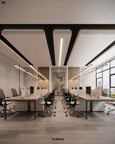 an empty office with desks and chairs in the center, along with large windows