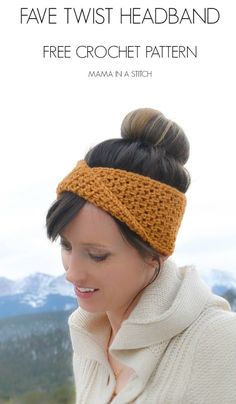 a woman wearing a knitted headband and looking at her cell phone with mountains in the background