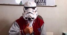 a person wearing a star wars mask and pointing at the camera